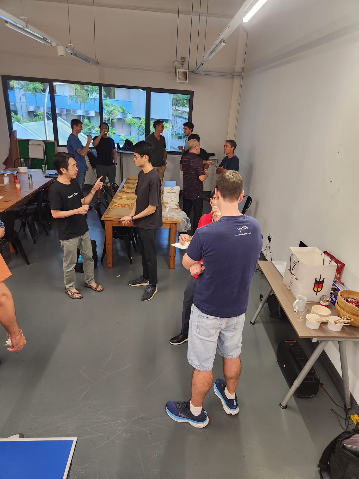 Vertical view of attendees standing and chatting near the tables